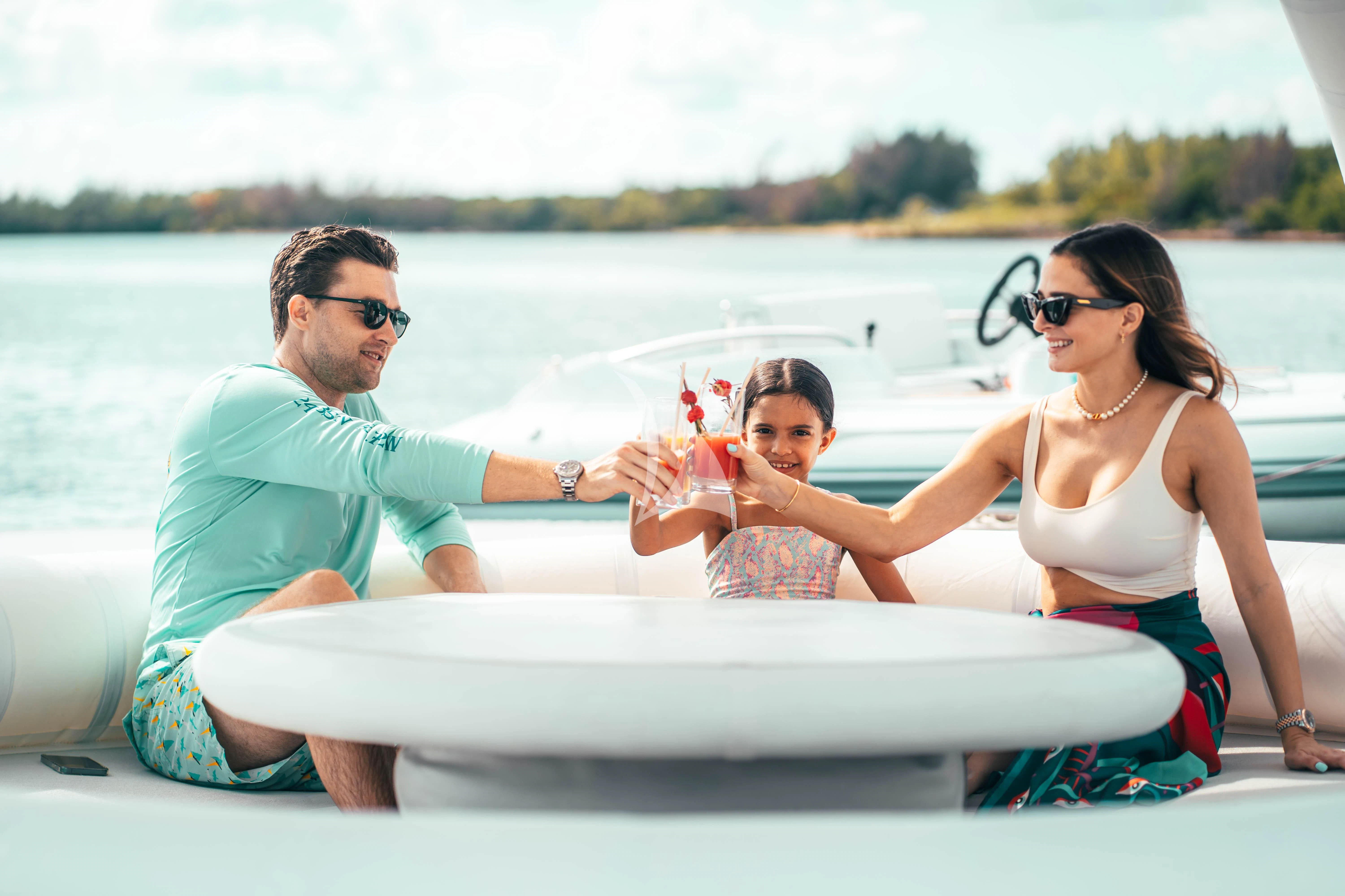 a man and woman and a baby in a boat aboard ARTEMISEA Yacht for Sale