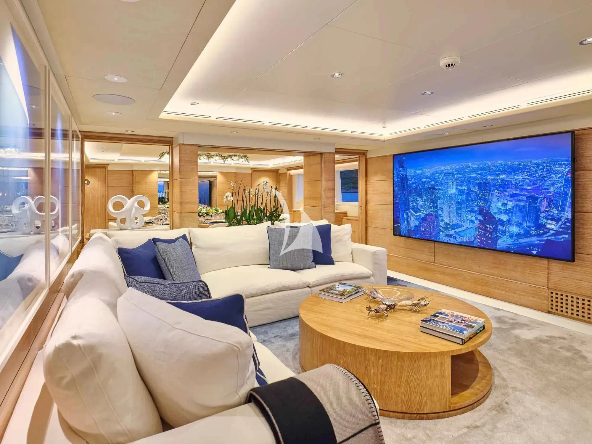 a living room with a large screen aboard ARTEMISEA Yacht for Sale