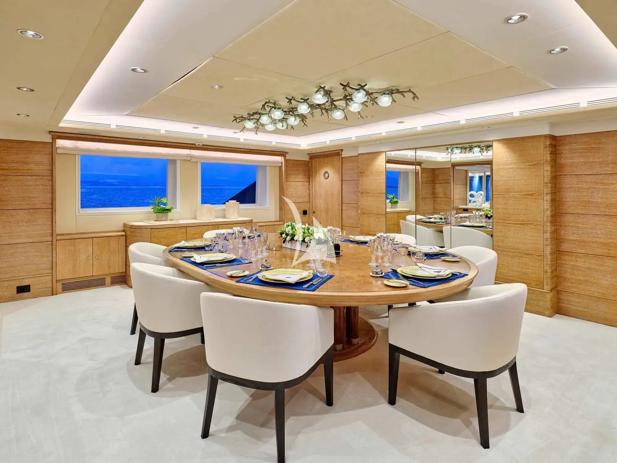 a dining table with chairs and a large window aboard ARTEMISEA Yacht for Sale