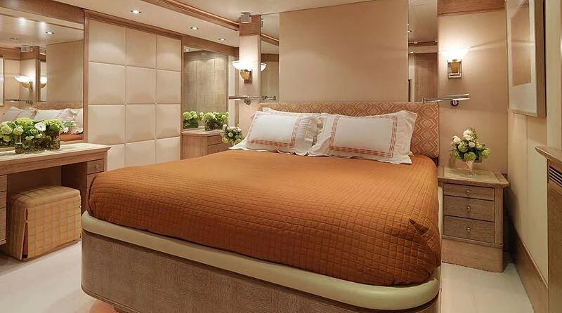 a bed with a white comforter aboard ARTEMISEA Yacht for Sale
