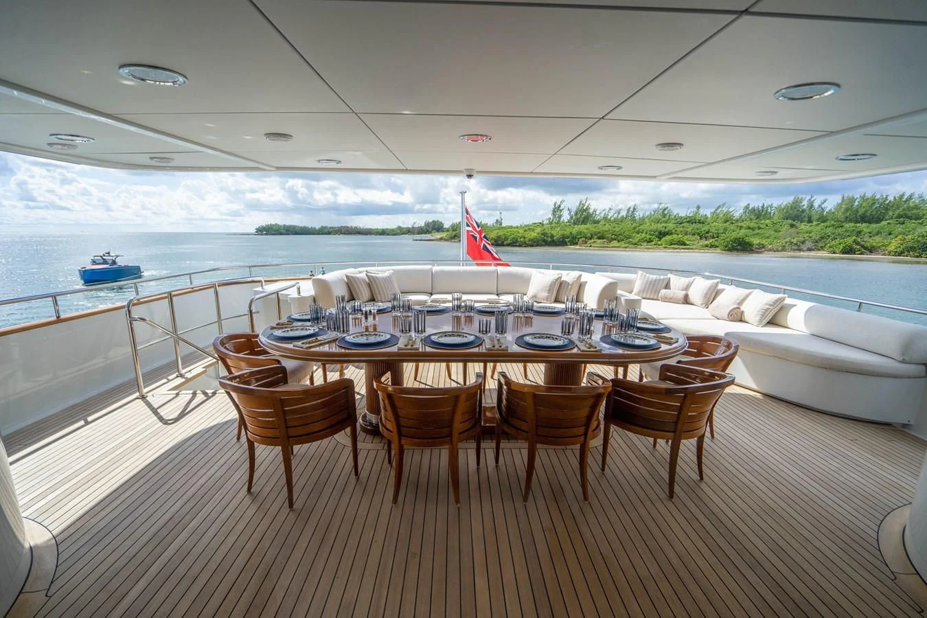 a table set for a meal on a deck overlooking a body of water aboard ARTEMISEA Yacht for Sale