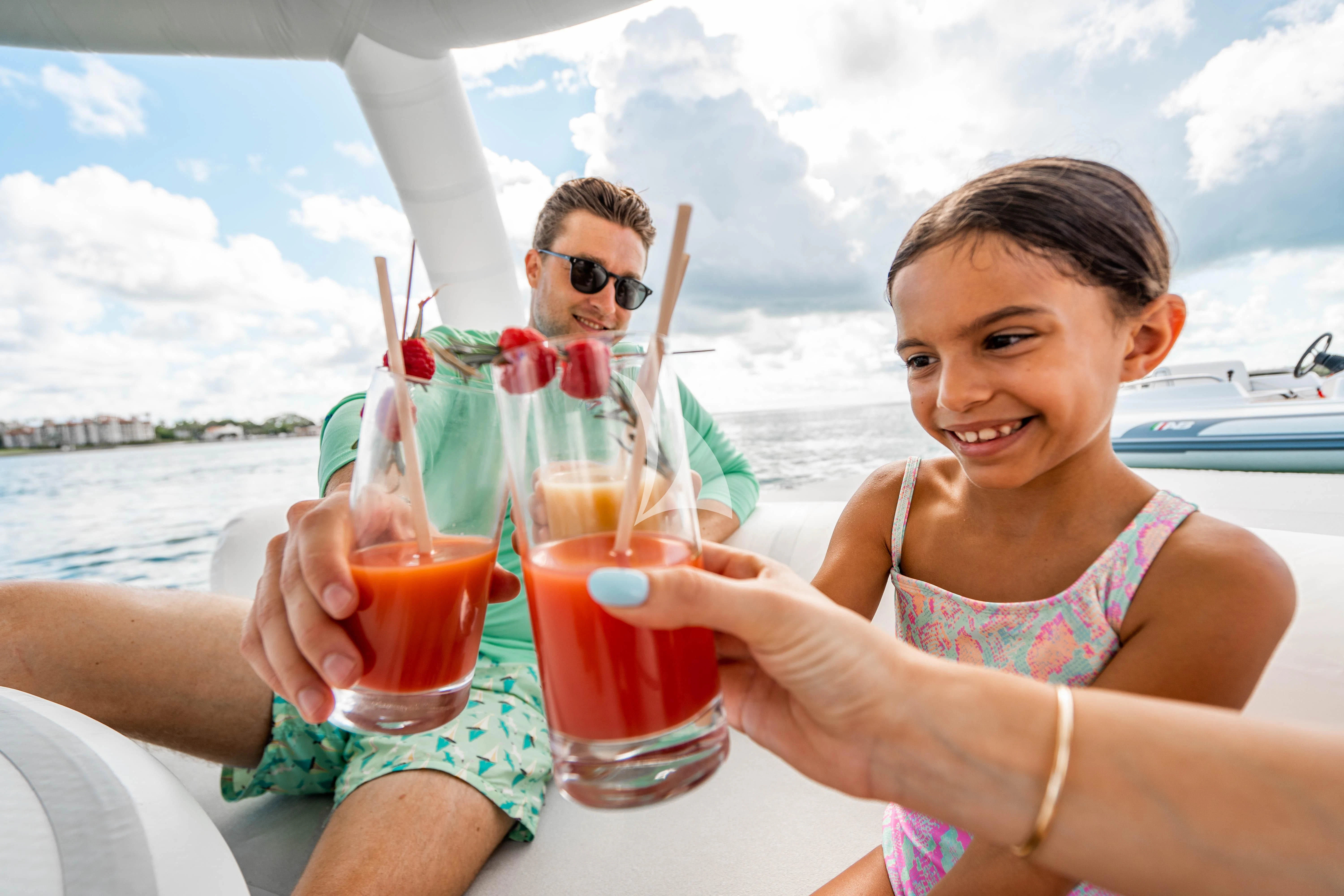 a man and woman holding drinks aboard ARTEMISEA Yacht for Sale