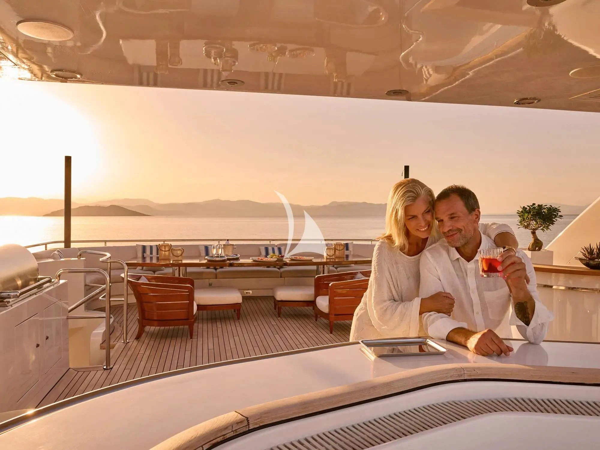 a man and a woman sitting at a table in a restaurant aboard ARTEMISEA Yacht for Sale