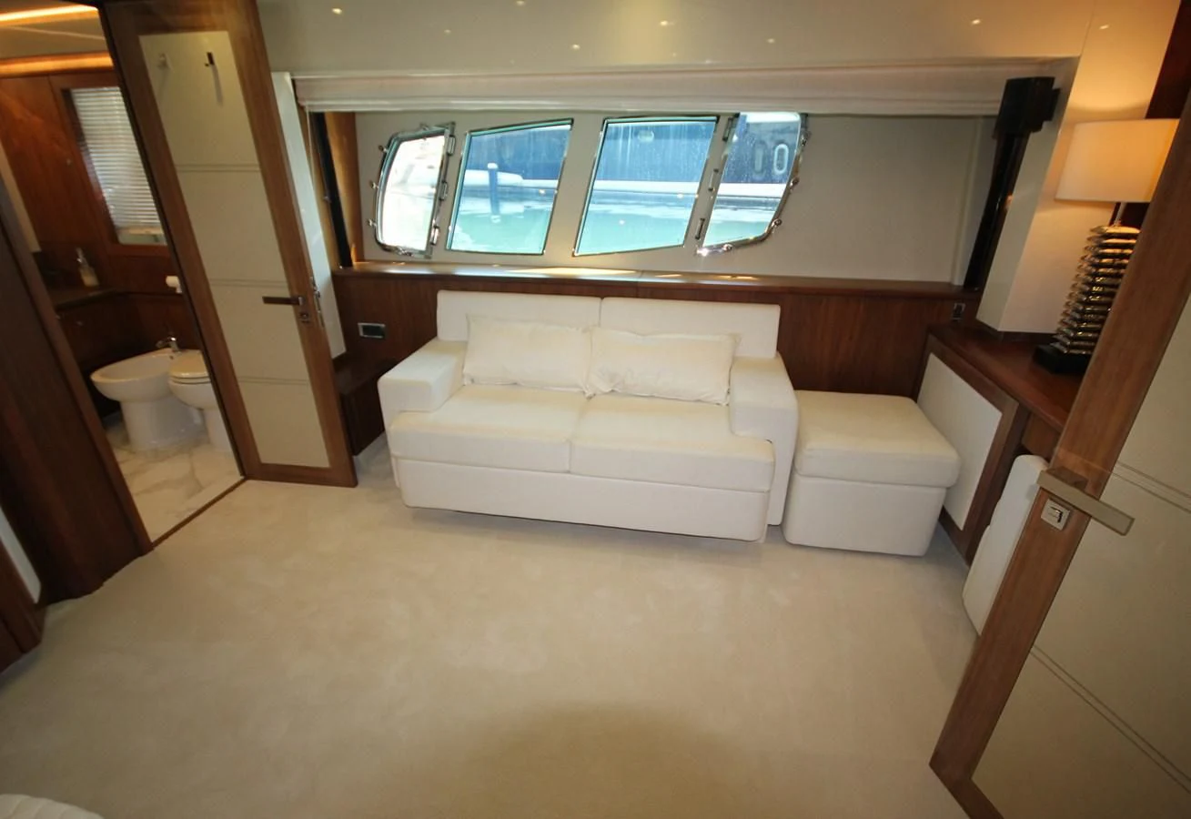 a living room with a couch and a window aboard COPPER 3 Yacht for Sale