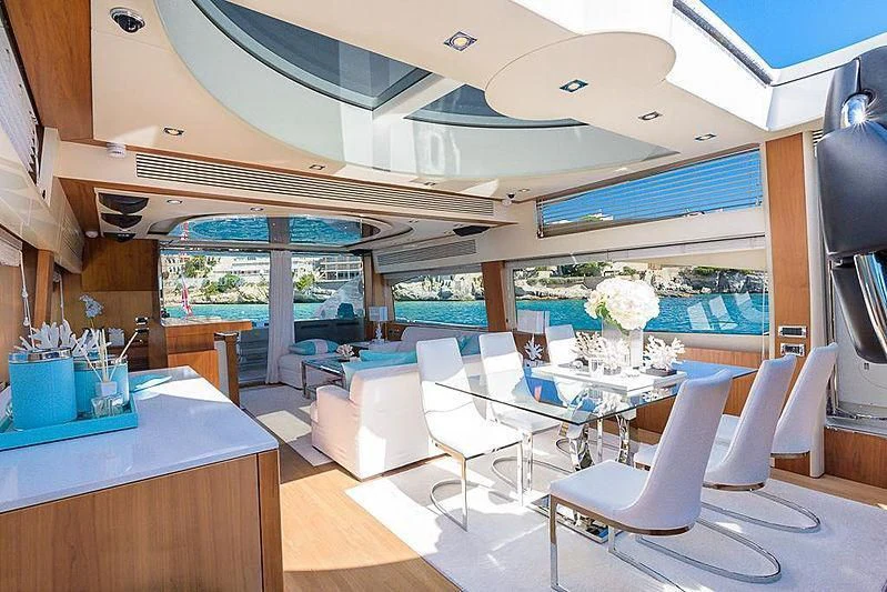 a room with a table chairs and a large window aboard COPPER 3 Yacht for Sale