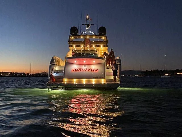 a group of people standing on a boat in the water aboard COPPER 3 Yacht for Sale