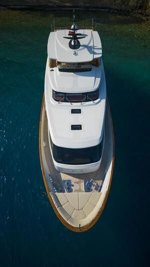 a white boat on a body of water aboard AQUILA Q Yacht for Sale
