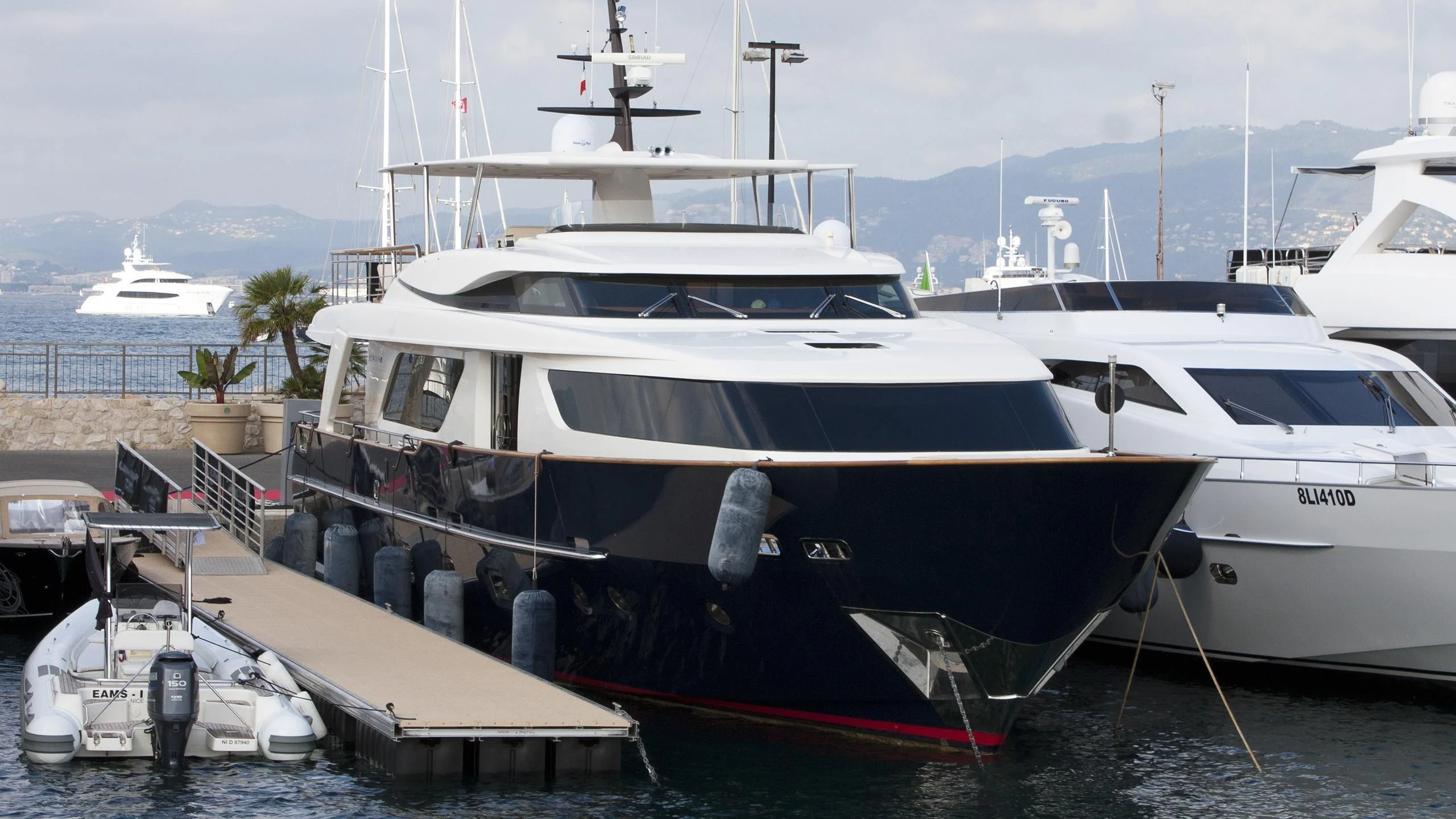 a boat docked at a pier aboard AQUILA Q Yacht for Sale