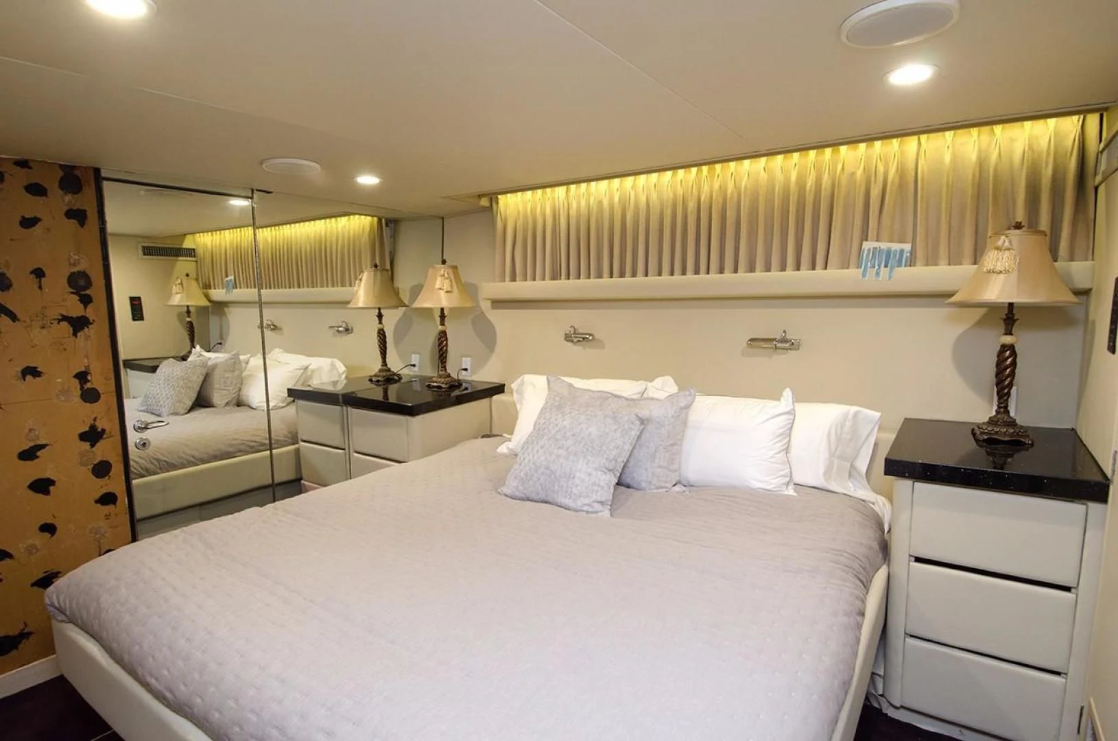 a bed with a white bed spread aboard GOLDEN TOUCH Yacht for Sale