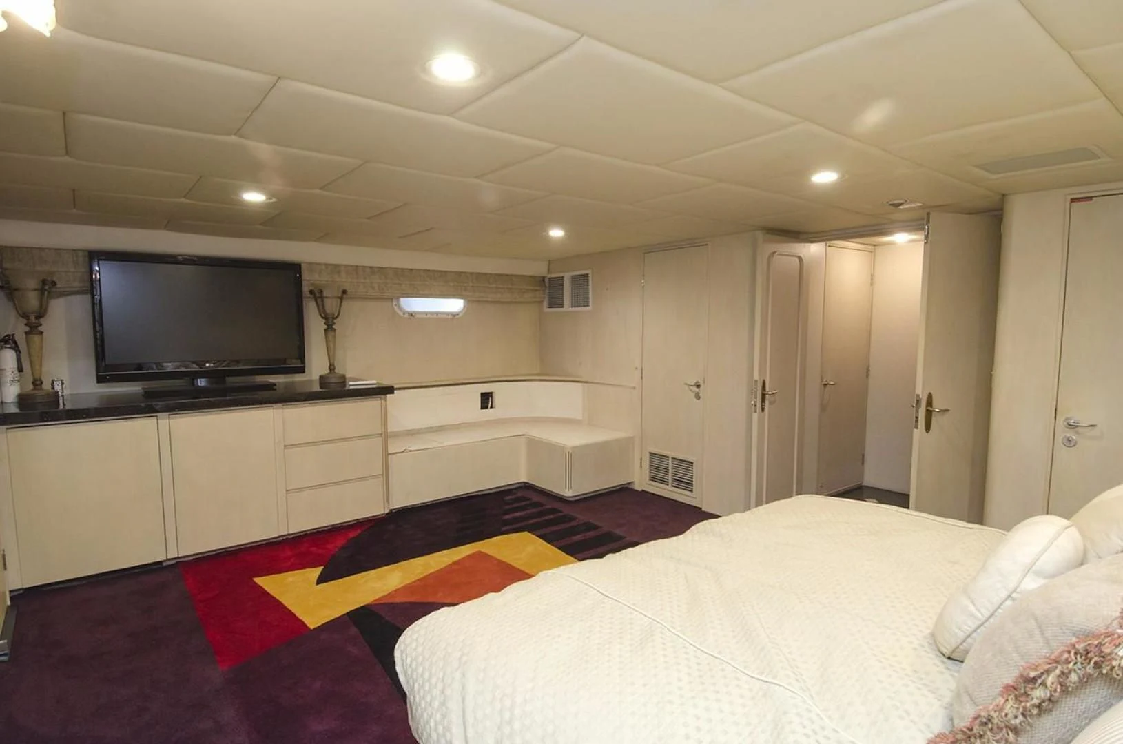 a hotel room with a tv and bed aboard GOLDEN TOUCH Yacht for Sale