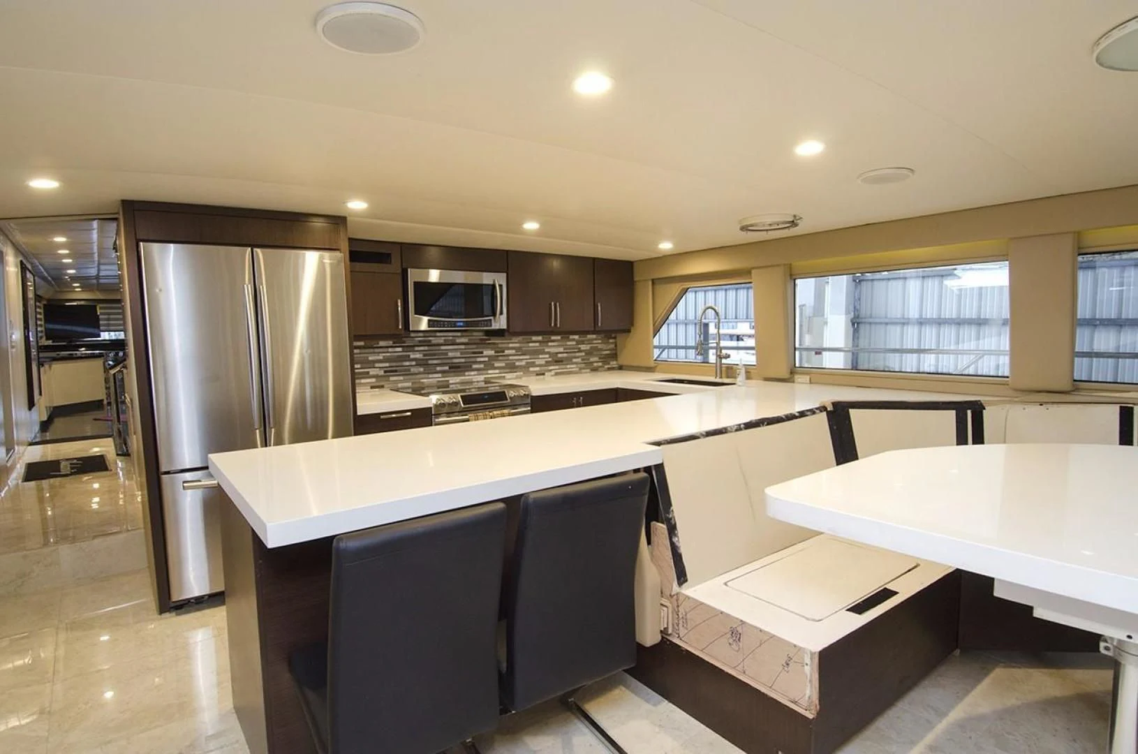 a kitchen with a refrigerator and a table aboard GOLDEN TOUCH Yacht for Sale