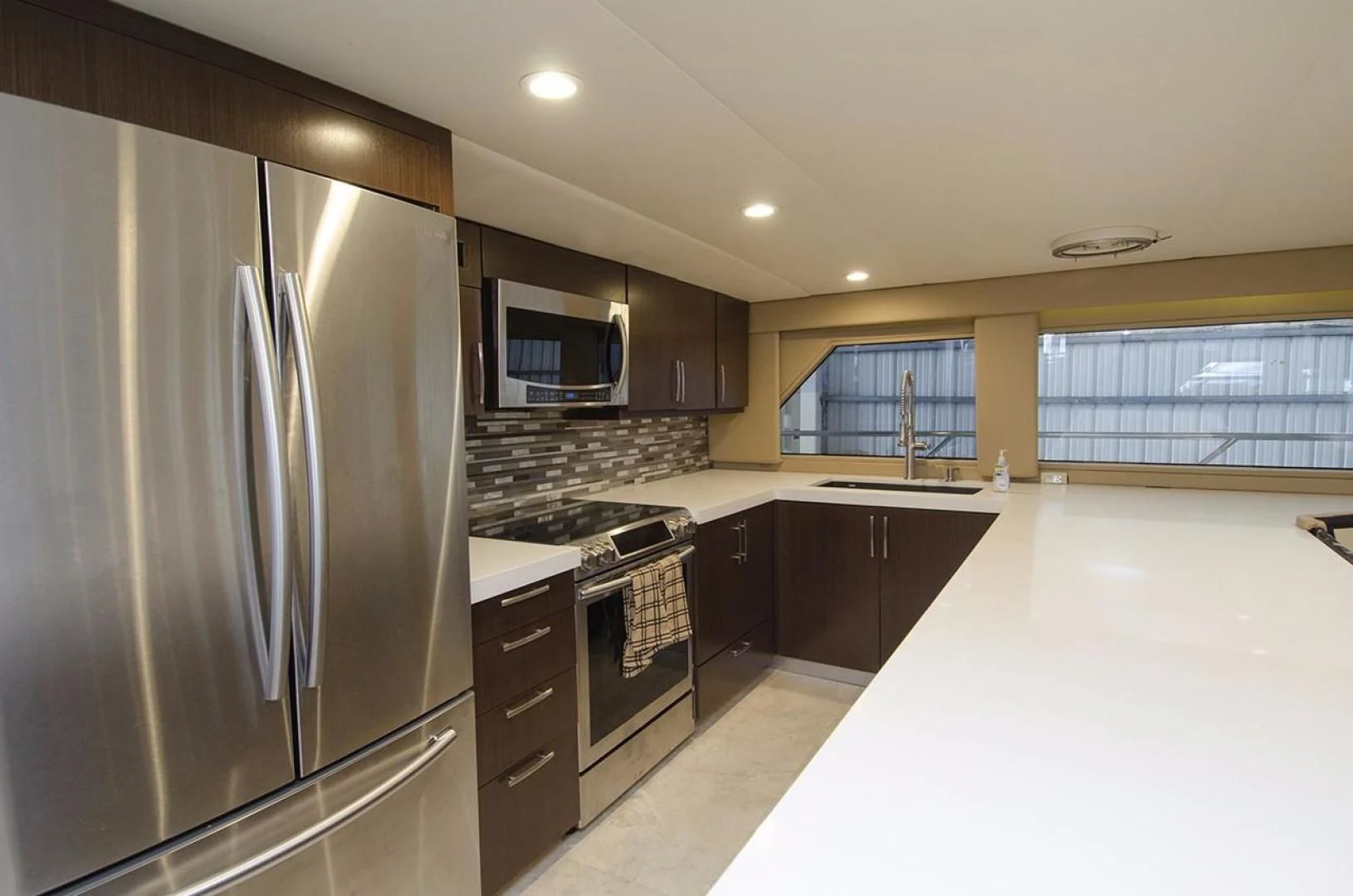a kitchen with a stainless steel refrigerator aboard GOLDEN TOUCH Yacht for Sale