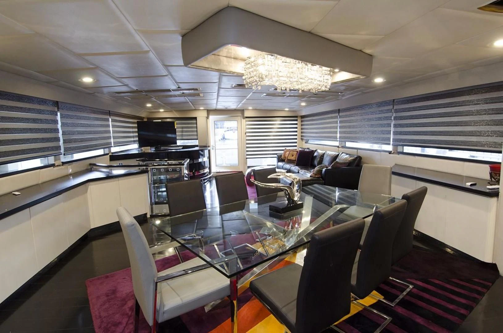 a room with a table chairs and a couch aboard GOLDEN TOUCH Yacht for Sale