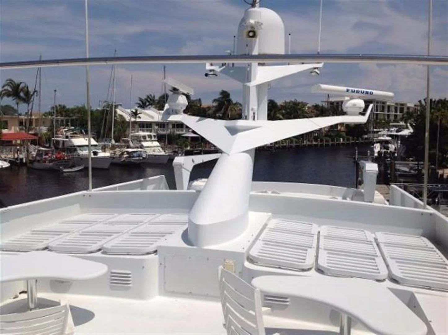 a deck with many white chairs and white chairs aboard GOLDEN TOUCH Yacht for Sale