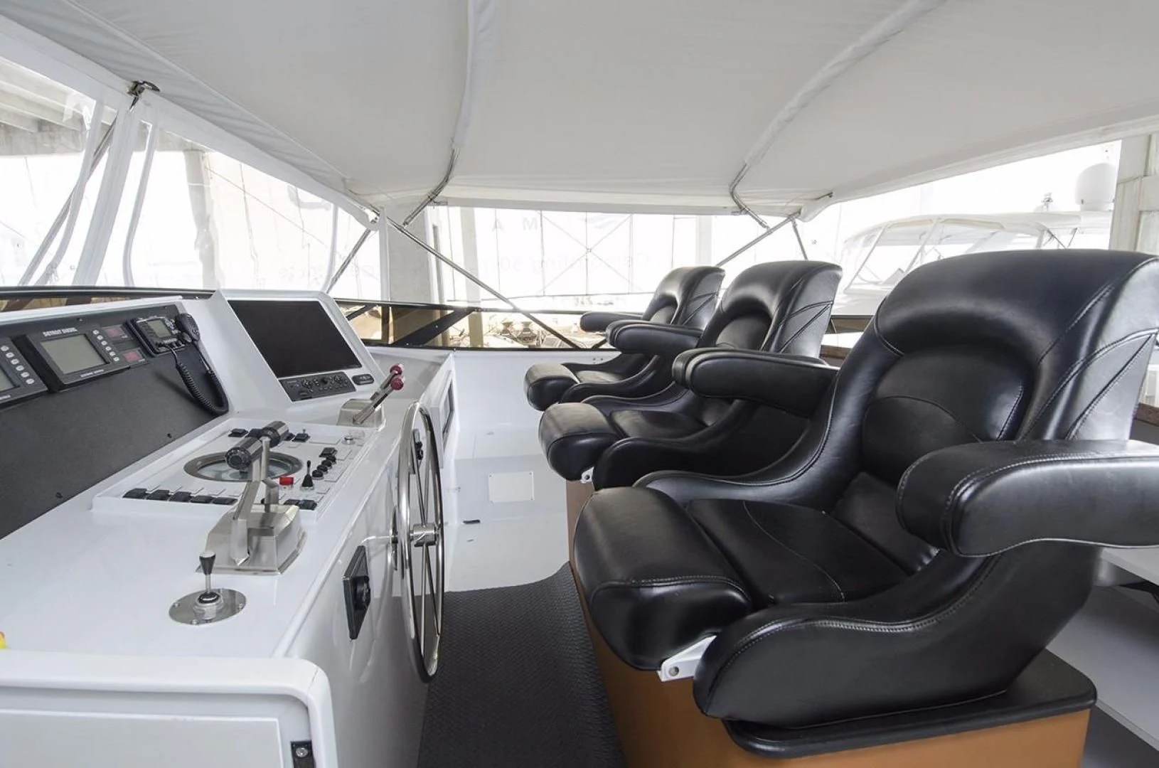 a black leather chair in a white room aboard GOLDEN TOUCH Yacht for Sale