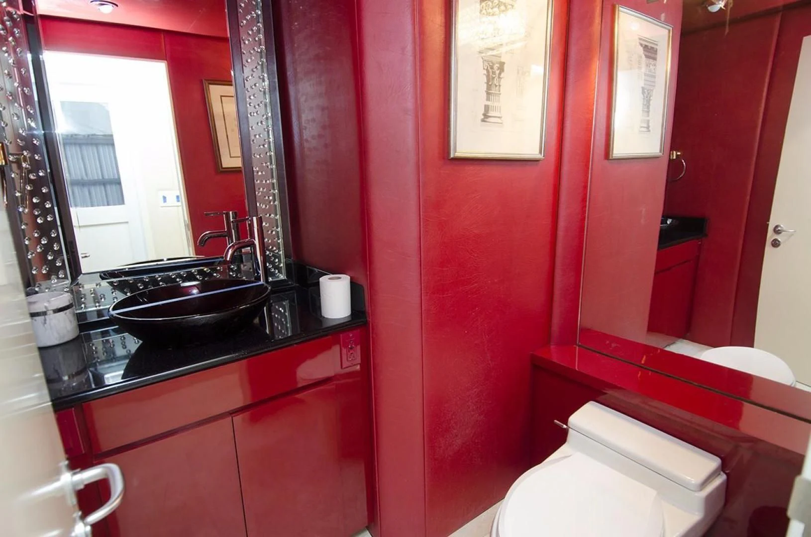 a bathroom with red walls aboard GOLDEN TOUCH Yacht for Sale