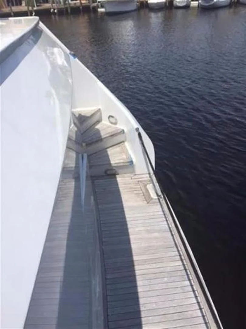a white boat on a dock aboard GOLDEN TOUCH Yacht for Sale