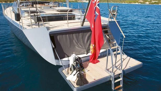 a boat with a red and white flag on it aboard SHARLOU Yacht for Sale