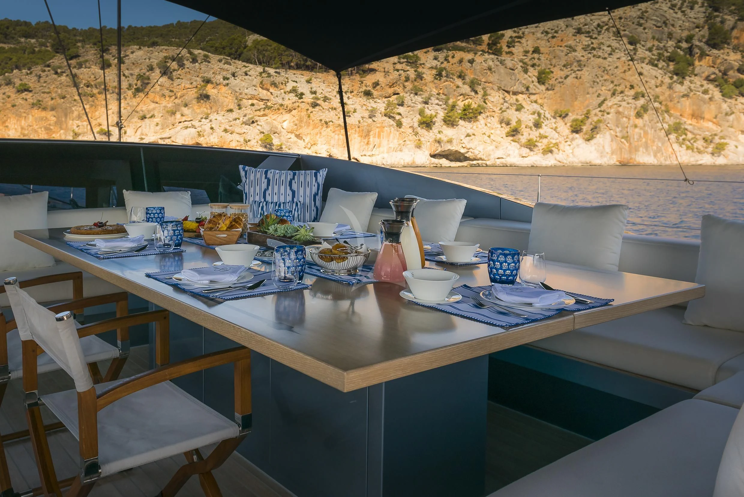 a table with plates and food on it aboard SHARLOU Yacht for Sale