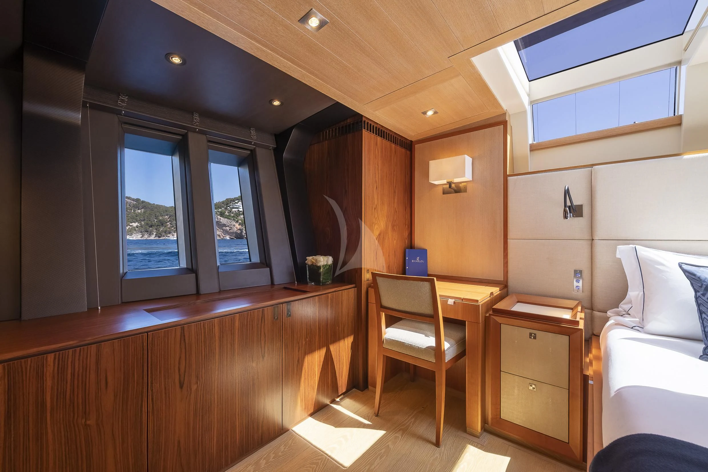 a room with a desk and a bed aboard SHARLOU Yacht for Sale