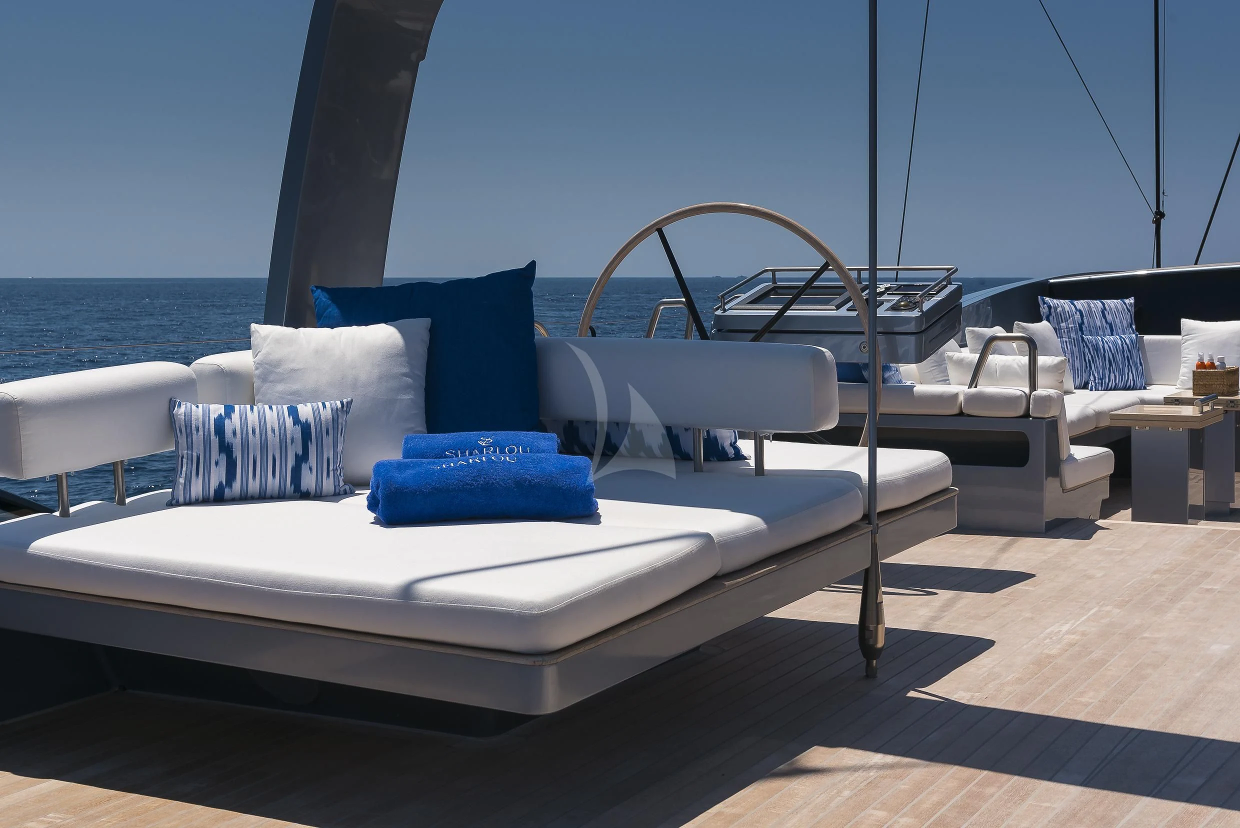 a white couch with blue pillows aboard SHARLOU Yacht for Sale
