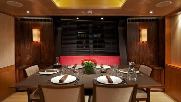 a table with plates and glasses aboard SHARLOU Yacht for Sale