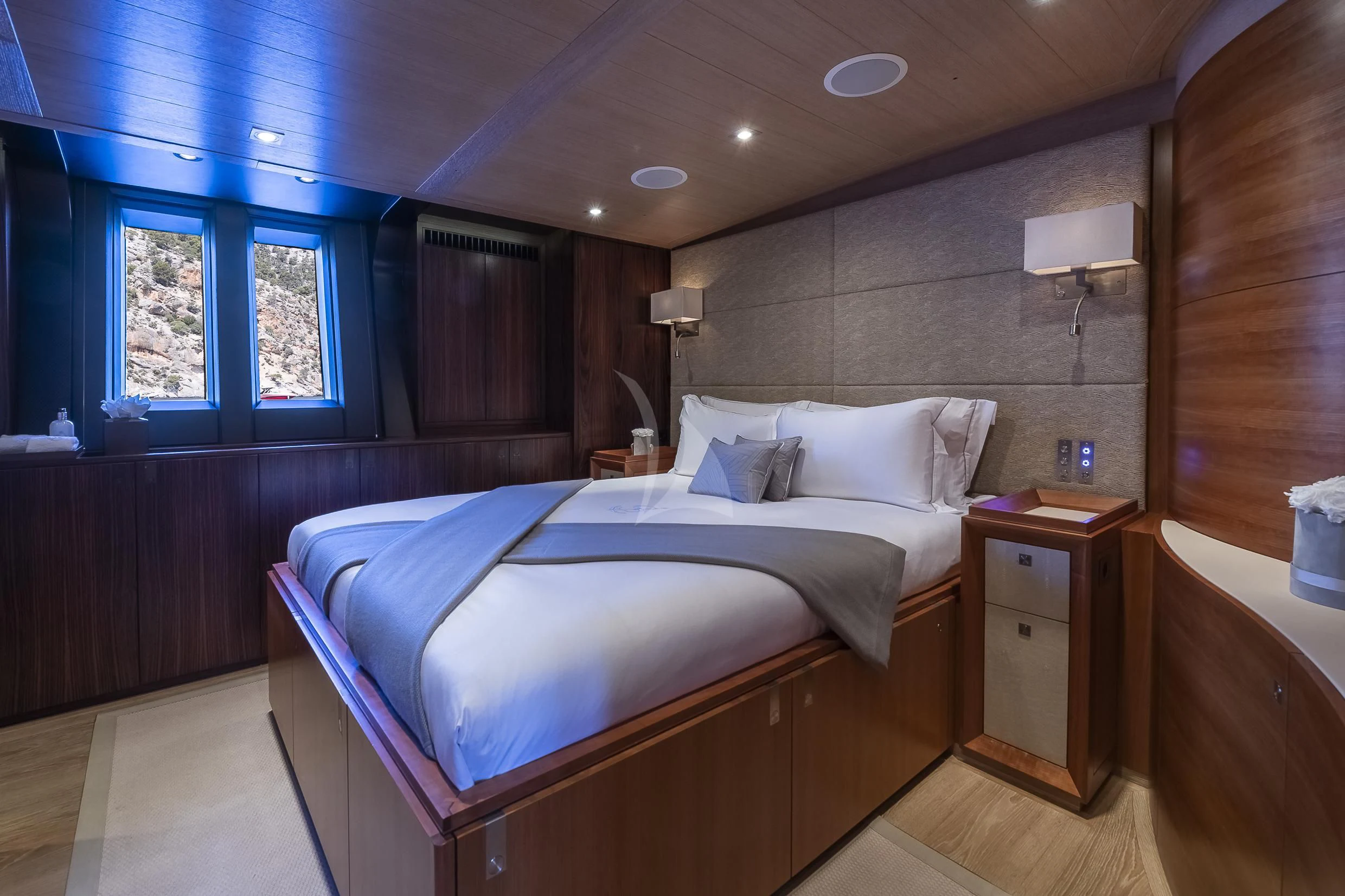 a bedroom with a bed and a desk aboard SHARLOU Yacht for Sale