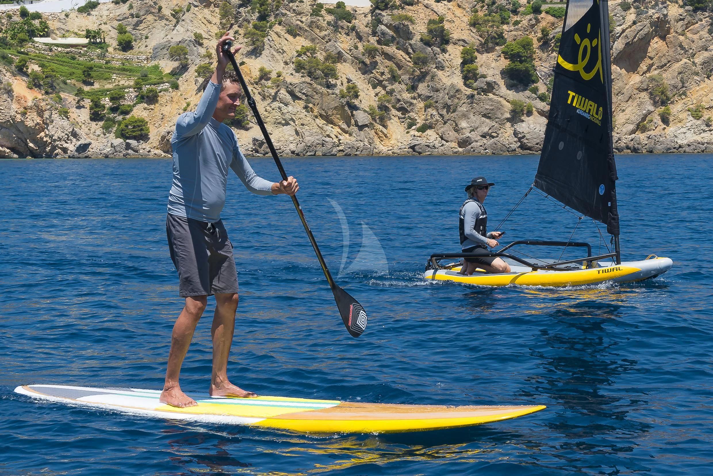 a man paddle boarding with a paddle aboard SHARLOU Yacht for Sale