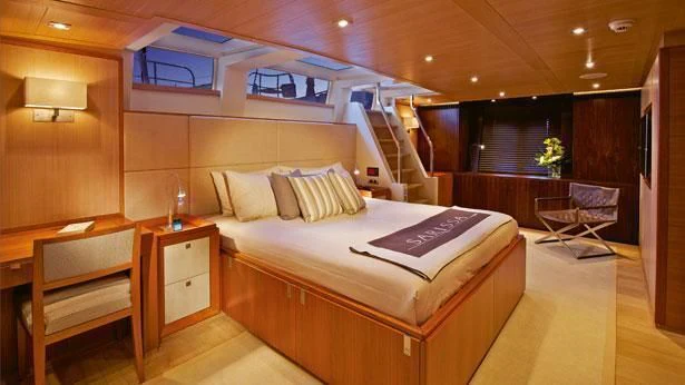 a room with a bed and a chair aboard SHARLOU Yacht for Sale