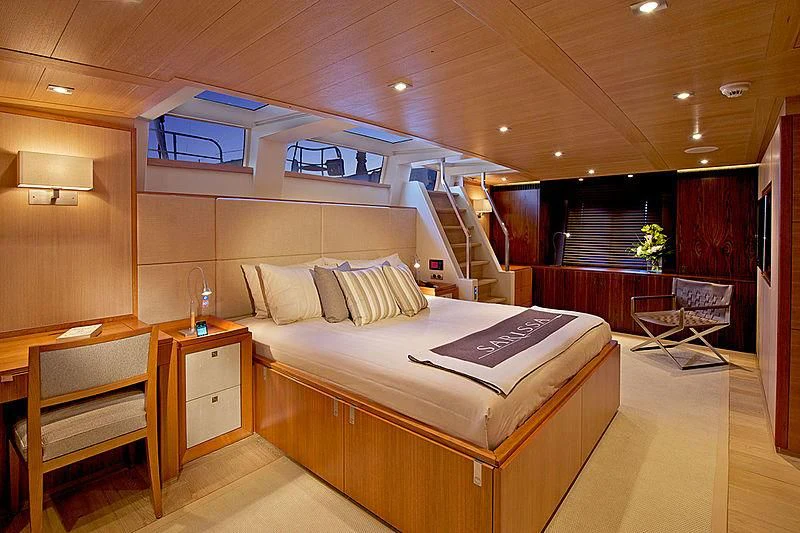 a large room with a bed and chairs aboard SHARLOU Yacht for Sale