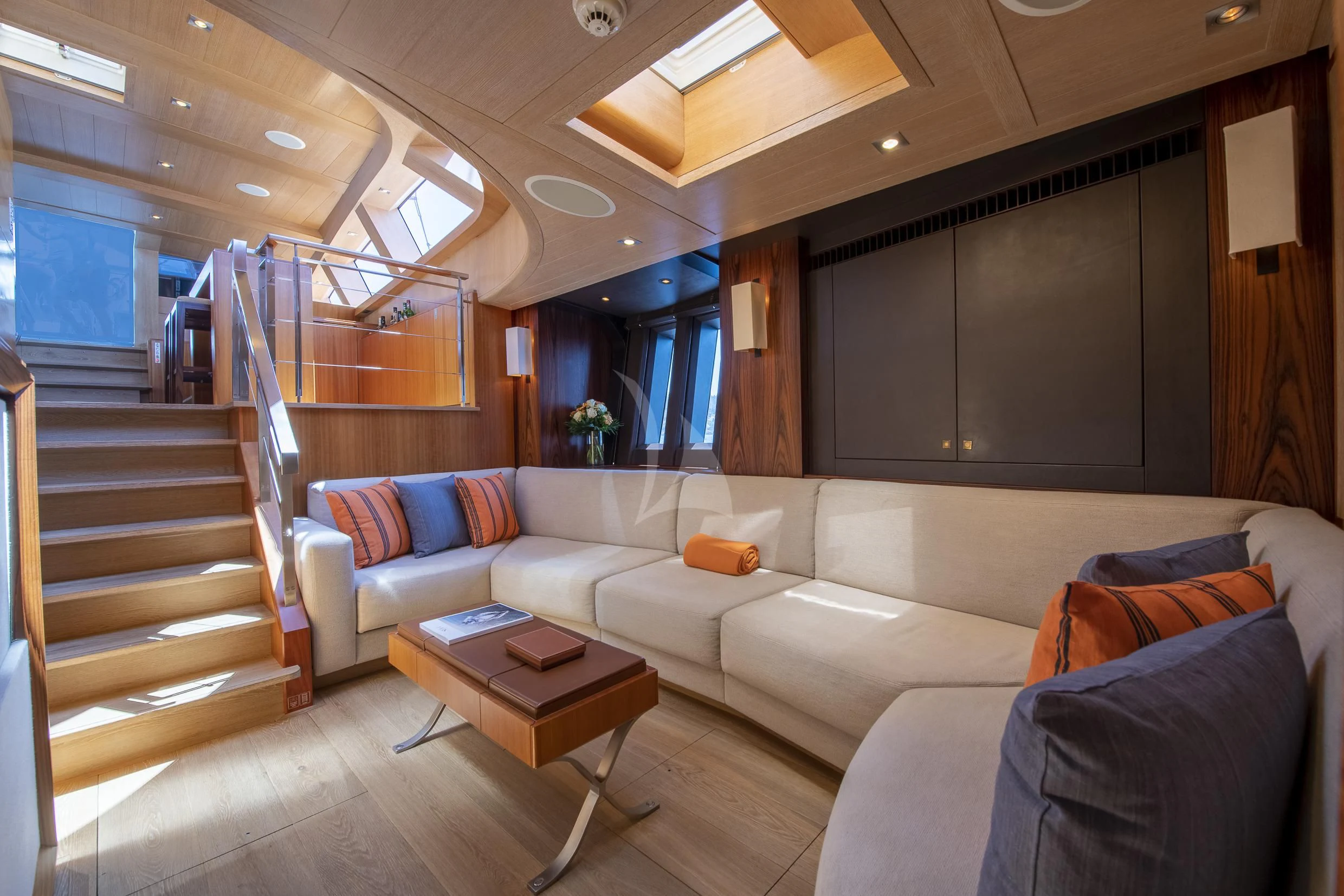 a living room with a staircase aboard SHARLOU Yacht for Sale