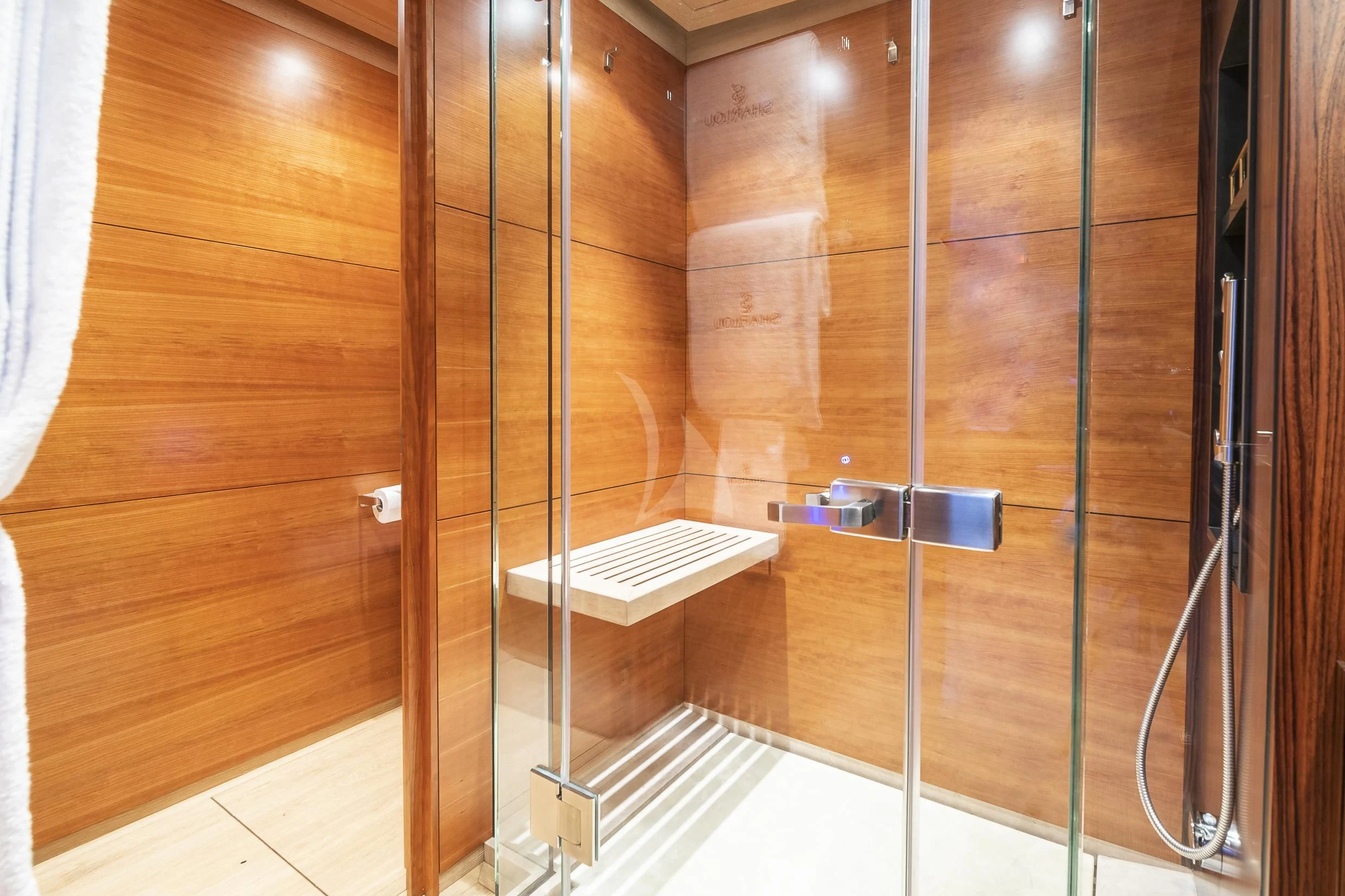 a bathroom with a glass shower aboard SHARLOU Yacht for Sale