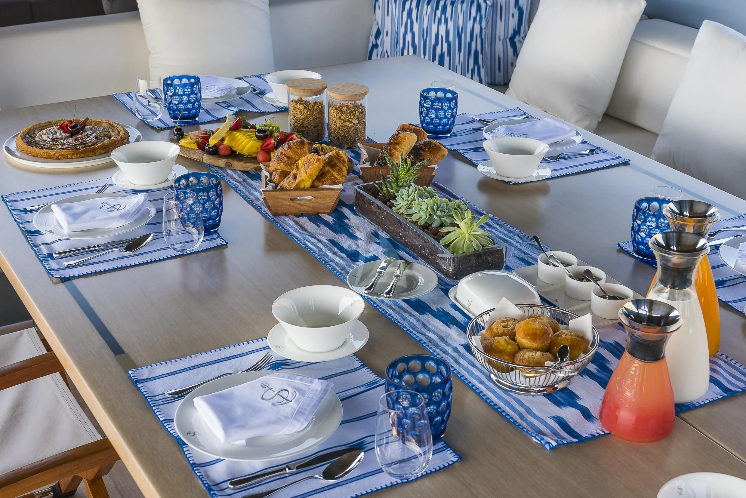a table with food and dishes on it aboard SHARLOU Yacht for Sale