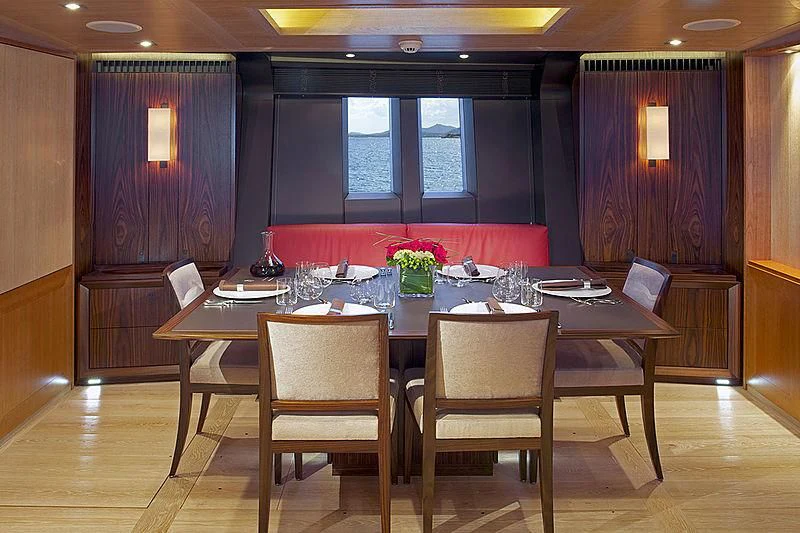 a dining table with chairs aboard SHARLOU Yacht for Sale