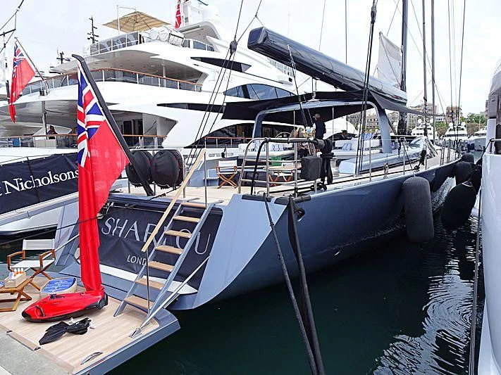 a boat with a flag on the front aboard SHARLOU Yacht for Sale