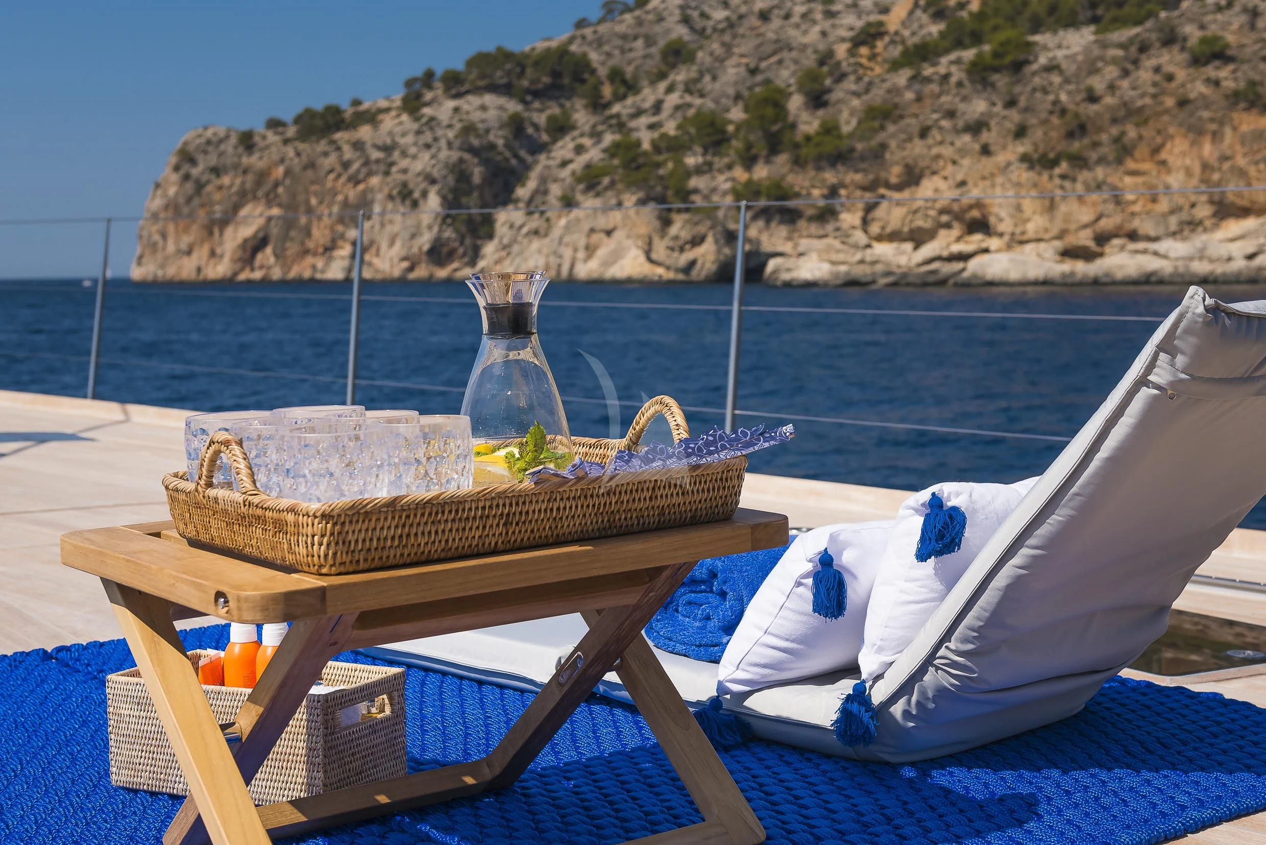 a table with a glass bottle and a straw on it aboard SHARLOU Yacht for Sale