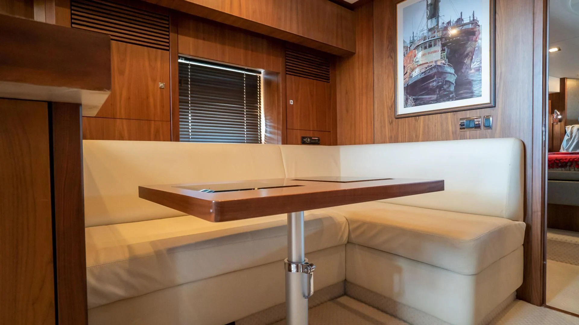 a room with a table and a bench aboard JIMBO Yacht for Sale