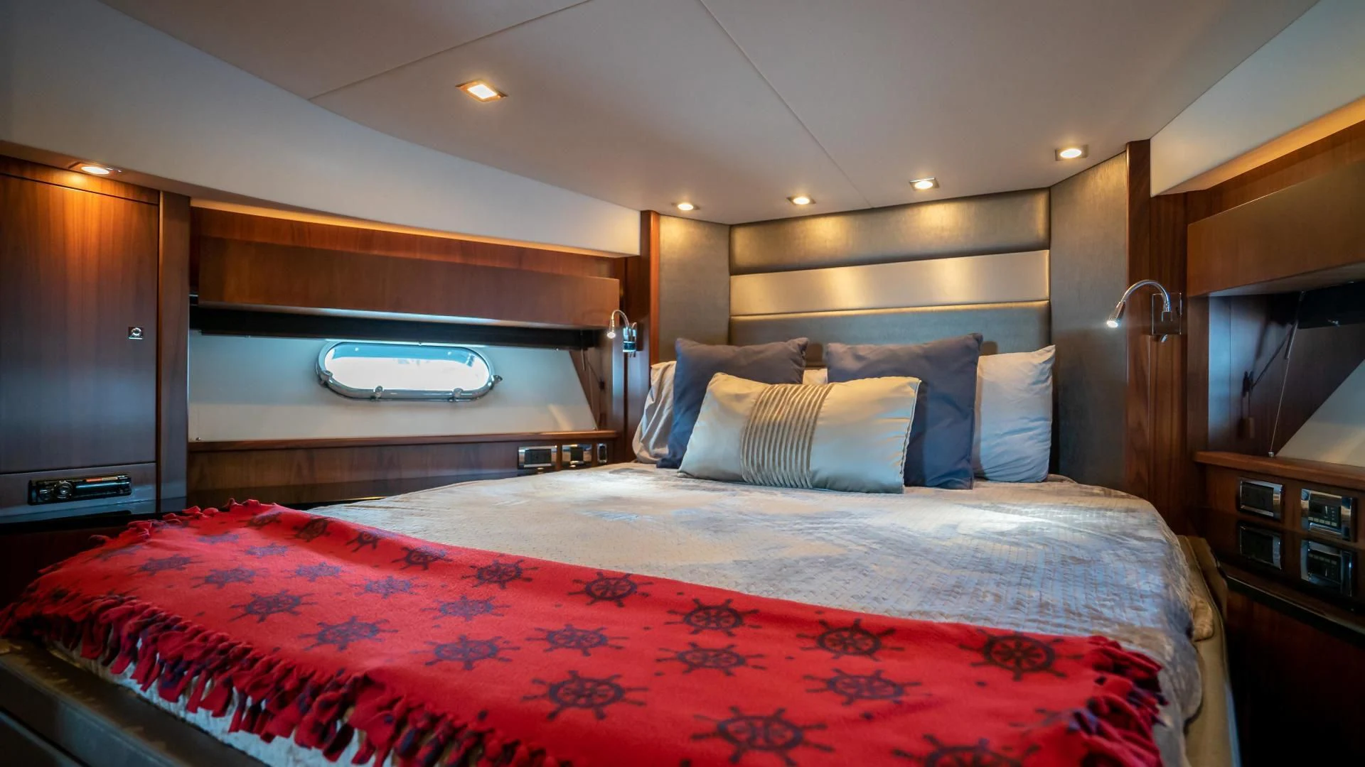 a bed with a red and white checkered blanket aboard JIMBO Yacht for Sale