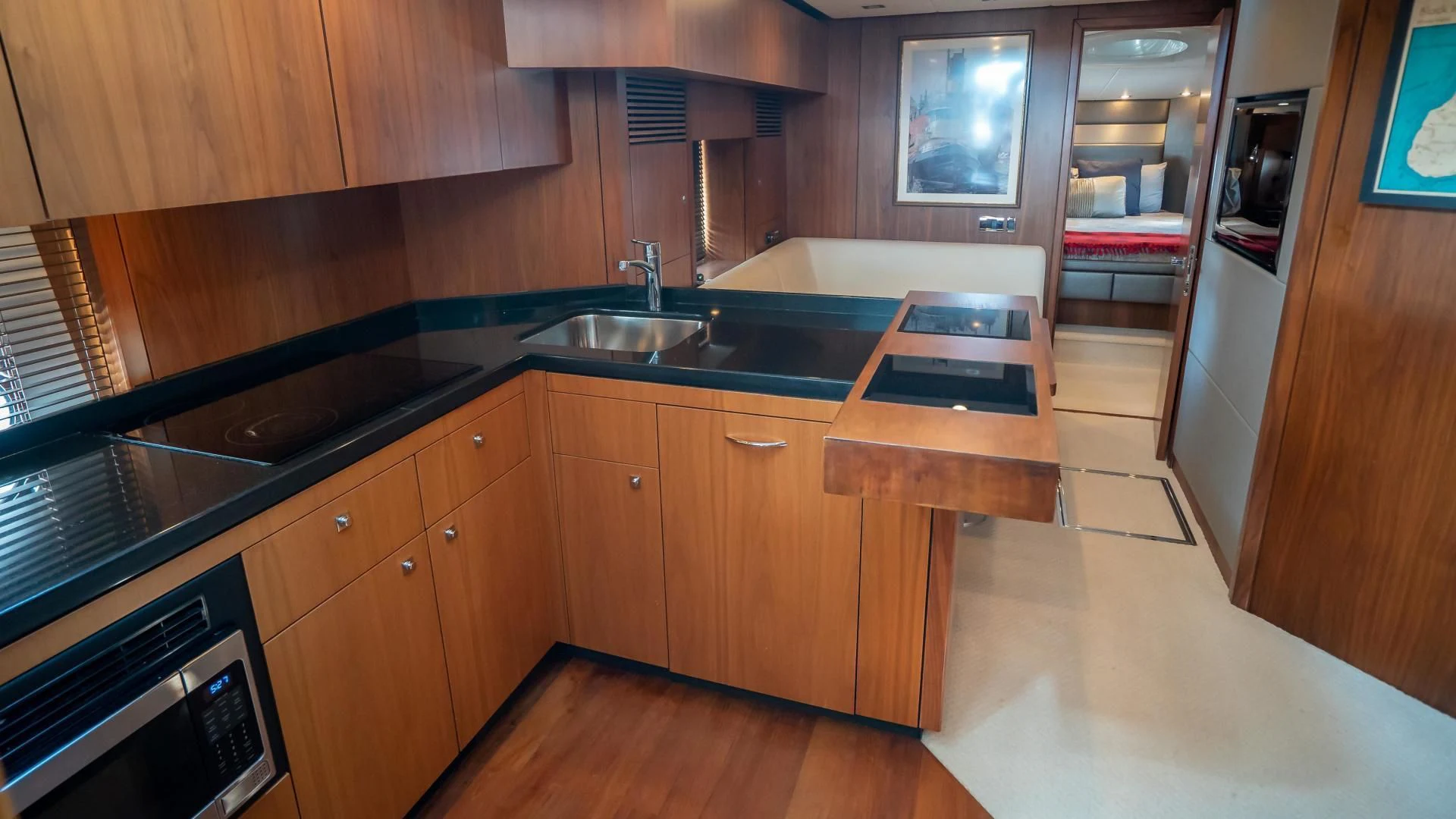 a kitchen with wooden cabinets aboard JIMBO Yacht for Sale