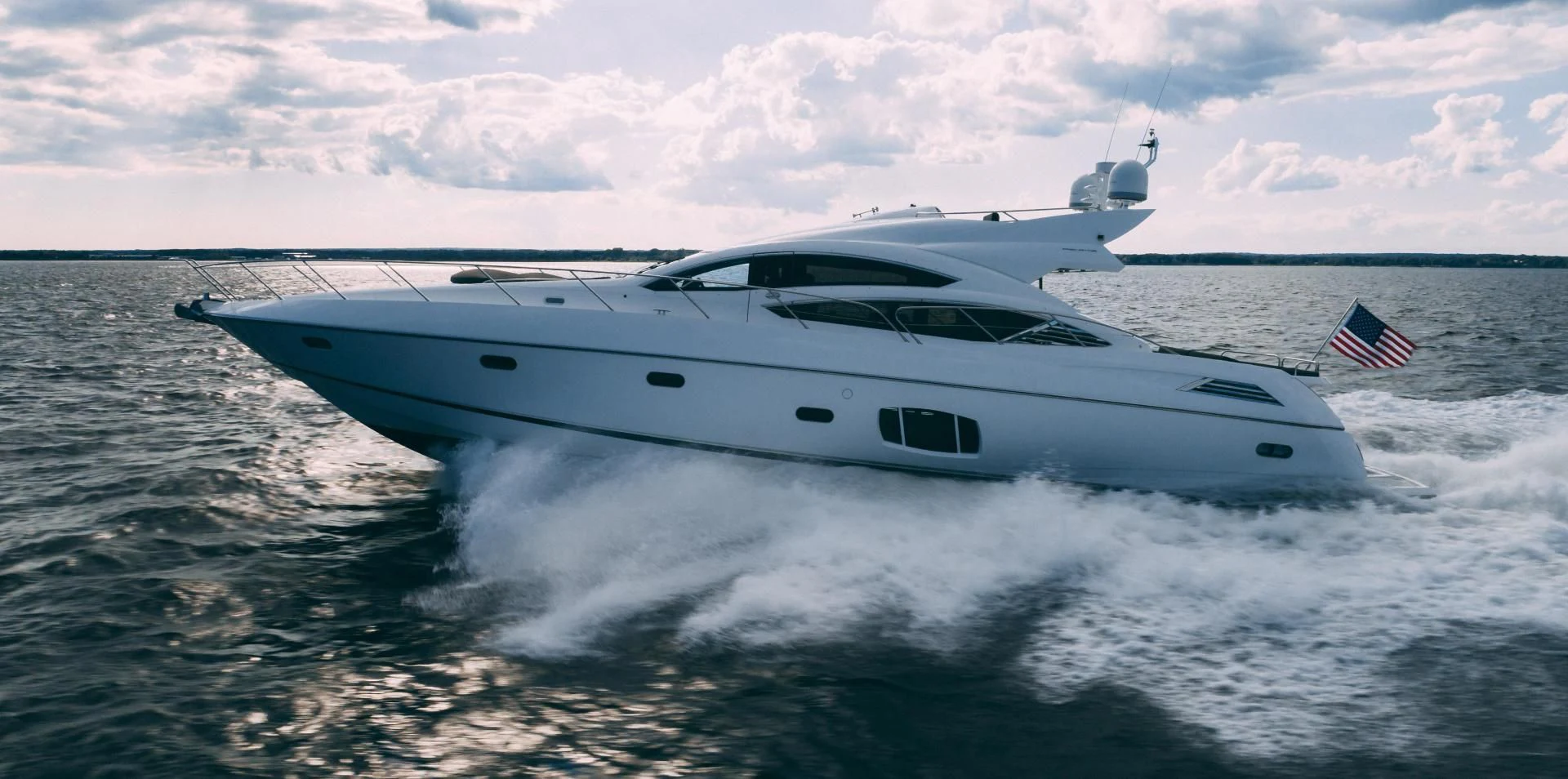 a white yacht on the water aboard JIMBO Yacht for Sale