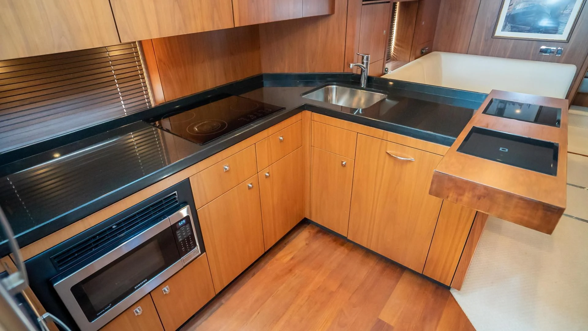 a kitchen with wooden cabinets aboard JIMBO Yacht for Sale