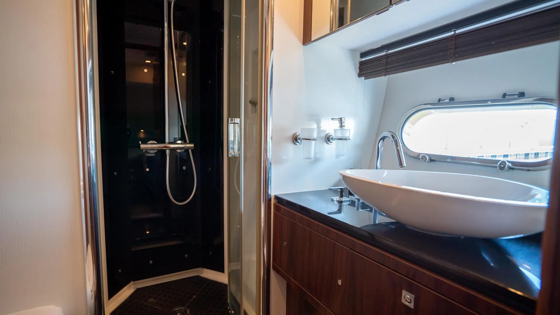 a bathroom with a sink and a large mirror aboard JIMBO Yacht for Sale
