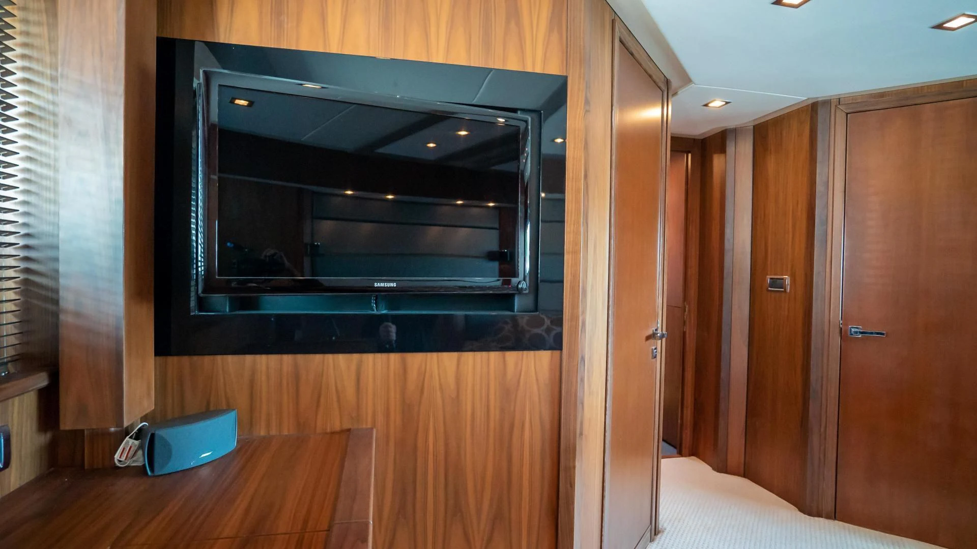 a black microwave oven on a wooden cabinet in a room aboard JIMBO Yacht for Sale