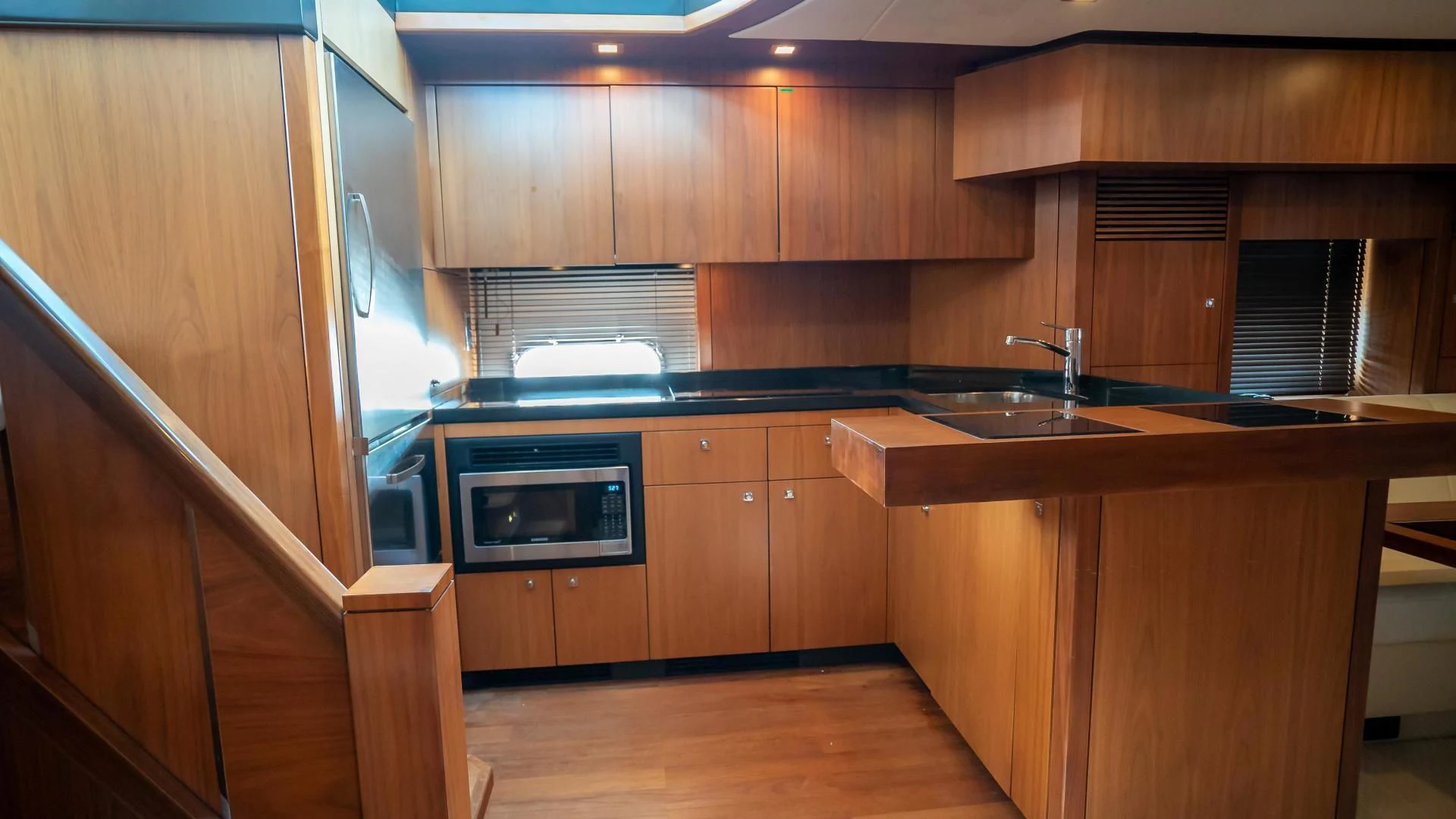 a kitchen with wooden cabinets aboard JIMBO Yacht for Sale