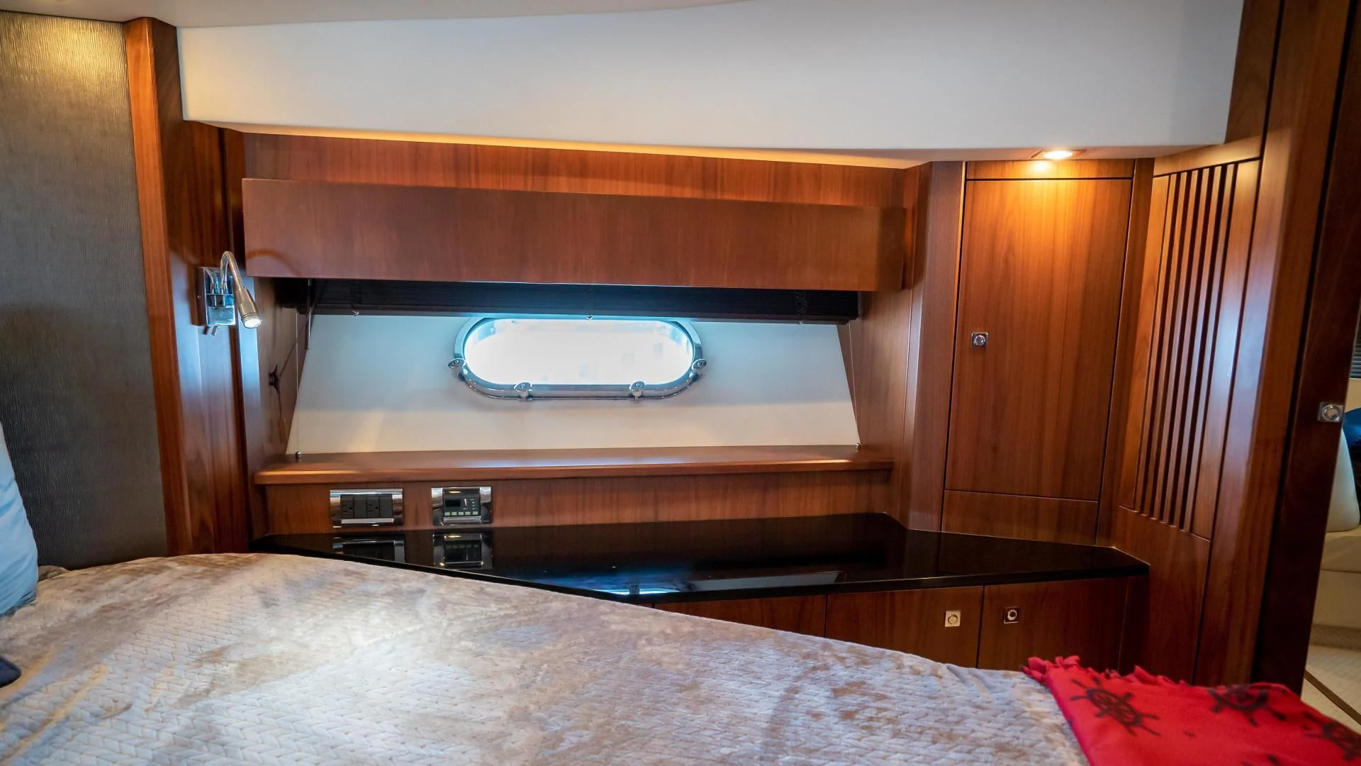 a bed with a window aboard JIMBO Yacht for Sale