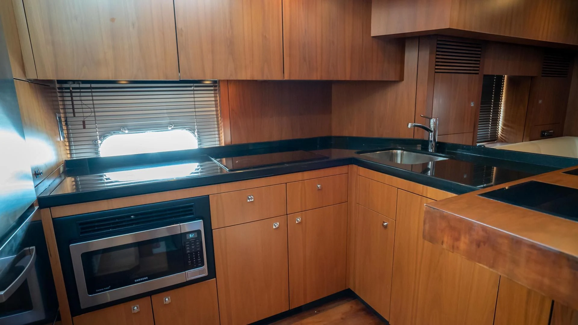 a kitchen with wooden cabinets aboard JIMBO Yacht for Sale
