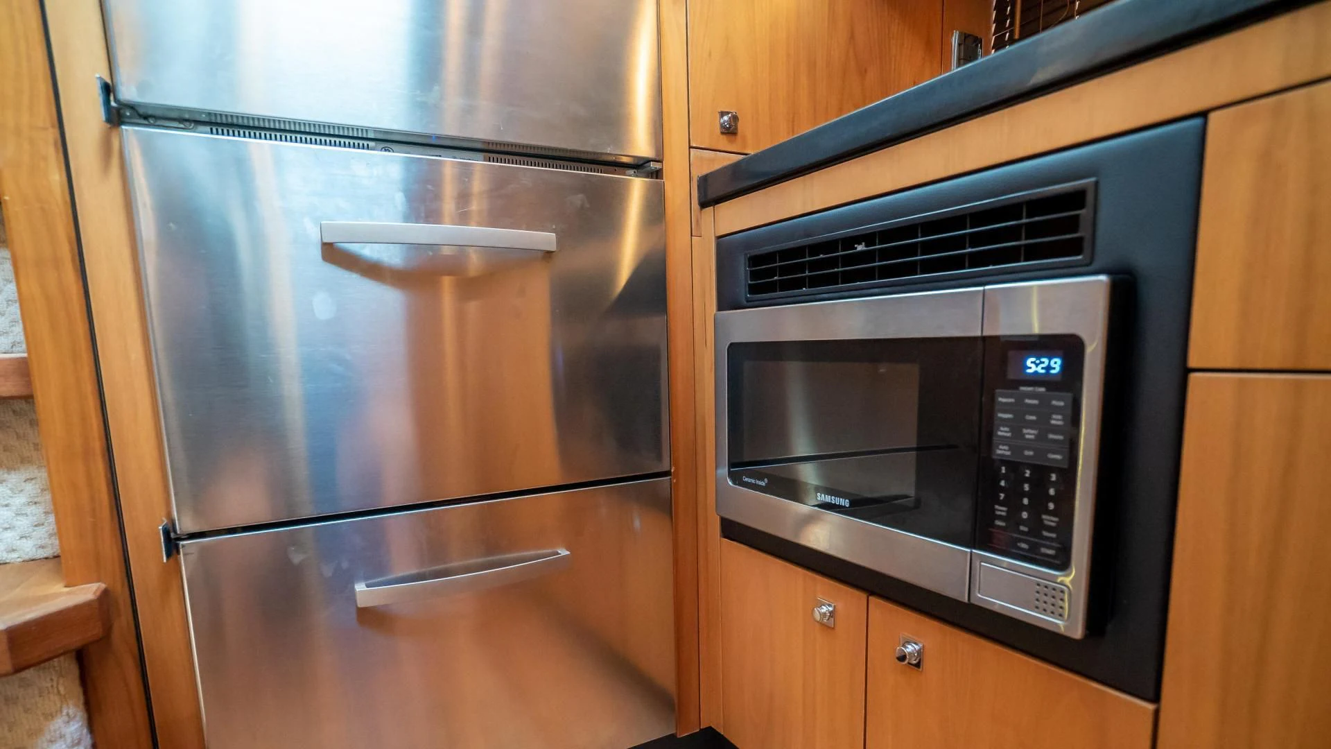 a stainless steel refrigerator in a kitchen aboard JIMBO Yacht for Sale