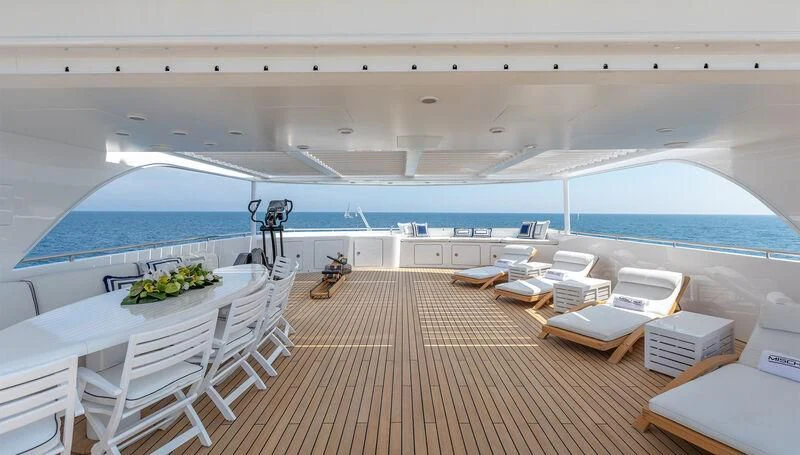 a room with a deck and a pool aboard MISCHIEF Yacht for Sale