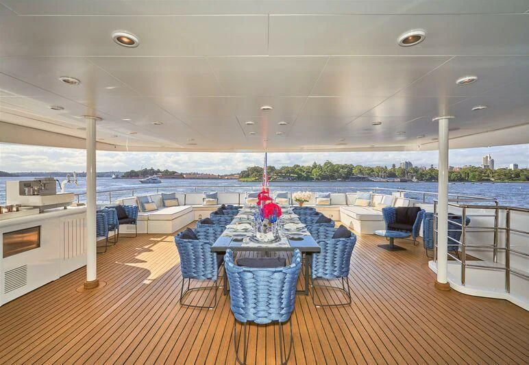 a room with a table chairs and a view of the water aboard MISCHIEF Yacht for Sale