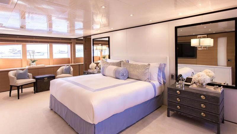 a bedroom with a bed and a couch aboard MISCHIEF Yacht for Sale